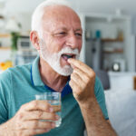A male senior taking a supplement